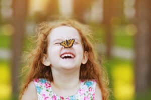girl with butterfly on nose